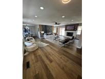 Open-concept living room with modern furnishings, fireplace, and hardwood floors at 3421 Fawn Trl, Marietta, GA 30066