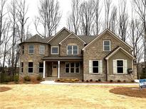 Two story house with brick facade and a three car garage at 4050 Sierra Vista Cir, Cumming, GA 30040