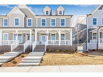Two-story craftsman home with front porch and brick facade at 152 Palm St, Holly Springs, GA 30115
