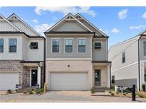 Gray three-story home with white garage door and landscaping at 734 Stickley Oak Way, Woodstock, GA 30189