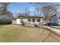 Charming white house with gray trim, covered porch, and manicured lawn at 777 Forrest Nw St, Atlanta, GA 30318