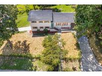 White ranch house with a gray roof, landscaping, and a long driveway at 5602 Westhill Cir, Atlanta, GA 30349