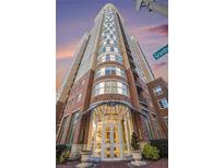 Luxury high-rise building with brick exterior and grand entrance at 325 E Paces Ferry Rd # 1110, Atlanta, GA 30305