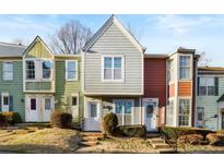 Three-unit townhouse community featuring a charming exterior and well-maintained landscaping at 6630 Ramsgate Way, Norcross, GA 30093