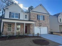 Two-story brick home with white accents, landscaping, and a two-car garage at 793 River Gardens Se Dr, Atlanta, GA 30354