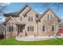 Charming two-story brick home featuring a manicured lawn, multi-pane windows, and a classic roofline at 2656 Old Norcross Rd, Tucker, GA 30084