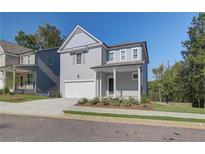 Two-story Craftsman style home with gray siding, white trim, and a two-car garage at 746 River Gardens Se Dr, Atlanta, GA 30354