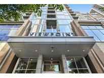 Modern high-rise building with glass facade and prominent signage at 855 Peachtree Ne St # 2911, Atlanta, GA 30308