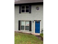 Cute gray brick home with a blue door and landscaping at 1299 Lakeview Nw Dr, Conyers, GA 30012