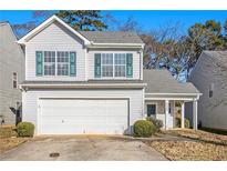 Two-story house with a white exterior, green shutters, and a two-car garage at 4260 Wesley Hall Dr, Decatur, GA 30035
