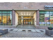 PeachTree Towers building entrance with double doors and landscaping at 300 W Peachtree St # 12A, Atlanta, GA 30308