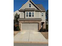Two-story house with gray siding, brick accents, and a two-car garage at 3109 Baylor Cir, Mcdonough, GA 30253