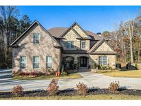 Brick two-story house with stone accents and a large driveway at 5195 Hamby Rd, Acworth, GA 30102