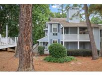 Inviting exterior of charming townhome with private deck and lush landscaping at 3960 Riverlook Pkwy # 101, Marietta, GA 30067