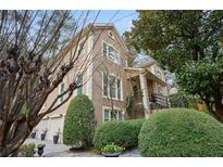 Exterior of charming two-story home with manicured landscaping and three-car garage at 1013 Lenox Valley Ne Dr, Atlanta, GA 30324