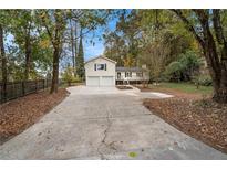 Ranch home with two-car garage and a large driveway at 2088 E Cherokee Dr, Woodstock, GA 30188