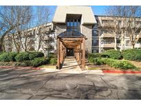 Inviting condo building entrance with stone accents and covered walkway at 1214 Highland Bluff Se Dr # 214, Atlanta, GA 30339