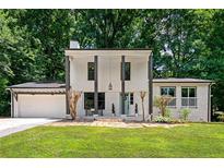 Updated ranch home features a fresh white exterior, landscaping, and a large driveway at 3059 Trafalgar Way, Atlanta, GA 30341