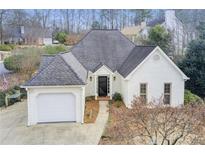 Charming single-Gathering home with white brick exterior and attached garage at 620 Oakledge Nw Dr, Marietta, GA 30060