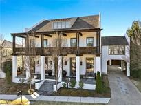 Two-story white home with dark brown accents, balconies, and a covered porch at 6870 Colfax Ave, Cumming, GA 30040