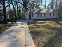 Ranch home with a paved driveway and a grassy yard at 3705 Daisy Dr, Decatur, GA 30032