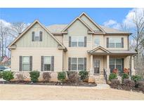 Two-story house with a neutral color scheme and landscaping at 609 River Hl, Mcdonough, GA 30252