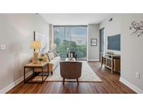 Spacious living room with hardwood floors and city views at 2795 Peachtree Ne Rd # 703, Atlanta, GA 30305