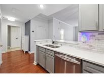 Modern kitchen with stainless steel appliances and white quartz countertops at 1101 Juniper Ne St # 415, Atlanta, GA 30309