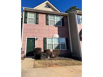 Brick townhouse with green door and landscaping at 5464 Sierra Trl, College Park, GA 30349