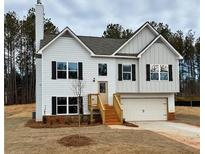 Charming two-story home with white siding, black shutters, and an attached two-car garage at 482 Charleston Pl, Villa Rica, GA 30180