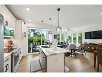 Modern kitchen with island, stainless steel appliances, and access to a private patio at 403 Pratt Se Dr # 1009, Atlanta, GA 30315