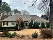 Ranch style home with stone accents and landscaped yard at 1540 Winding Creek Cir, Snellville, GA 30078