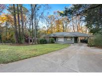 Ranch home with driveway and mature trees on a large lot at 2670 Eastwood Dr, Decatur, GA 30032