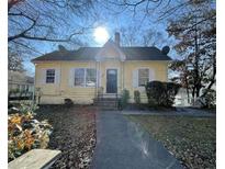 Charming yellow house with front porch and walkway at 1294 N Avenue Nw, Atlanta, GA 30318