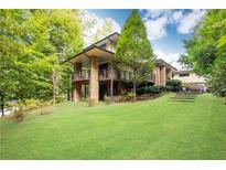 Contemporary house with stone accents and a spacious lawn at 4373 Wieuca Ne Rd, Atlanta, GA 30342