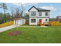 Two-story craftsman style home with detached garage and landscaped lawn at 1330 Sw Adams Dr, Atlanta, GA 30311