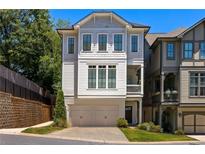 Three-story home with light-grey siding, two-car garage, and a balcony at 770 Grove Bnd, Decatur, GA 30030