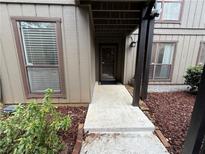 Inviting condo entrance with walkway, landscaping, and private access at 2201 Cumberland Se Ct, Smyrna, GA 30080