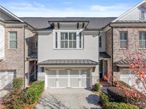 Stunning brick front exterior of townhome with 2-car garage at 3939 Glenview Club Ln, Duluth, GA 30097