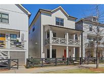 Two-story home with gray siding, a red door, and a black fence at 2357 Rover Ct, Atlanta, GA 30317