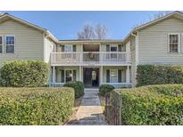 Inviting exterior of a two-story condo building with well-manicured landscaping at 1945 Brian Way, Decatur, GA 30033