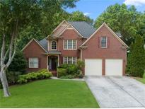 Brick two-story house with two-car garage and landscaped lawn at 156 Vine Creek Dr, Acworth, GA 30101