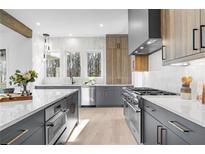 Modern kitchen with gray cabinetry, quartz countertops, and high-end appliances at 160 Cedarwood Ln, Roswell, GA 30075