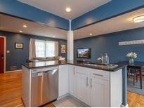 Modern kitchen features white cabinets, granite countertops, and stainless steel appliances at 2810 Frontier Trl, Atlanta, GA 30341