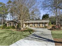 Ranch home with mature landscaping, long driveway and large backyard at 3089 Castaway Ln, Atlanta, GA 30341