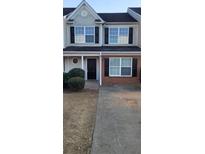 Two-story townhome with neutral siding, brick accents, and a paved driveway at 930 Parkway Rd, Union City, GA 30291