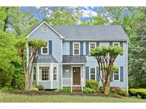 Charming two-story home with blue siding, a bay window, and a well-manicured front yard at 3616 Longfellow Trl, Marietta, GA 30062