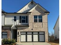 Charming brick and siding home featuring a two-car garage and well-maintained landscaping at 226 Depot Landing Rd # 56, Auburn, GA 30011