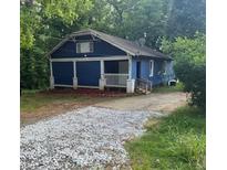 Charming one story house with blue siding and a gravel driveway at 1116 Northwest Nw Dr, Atlanta, GA 30318