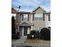 Two-story townhome with neutral siding and landscaping at 2962 Vining Ridge Ln, Decatur, GA 30034